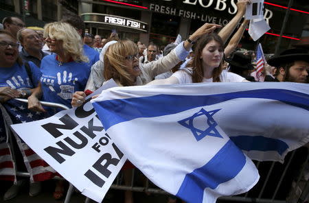 Protestors shout slogans as they demonstrate with thousands of others during a rally apposing the nuclear deal with Iran in Times Square in the Manhattan borough of New York City, July 22, 2015. REUTERS/Mike Segar