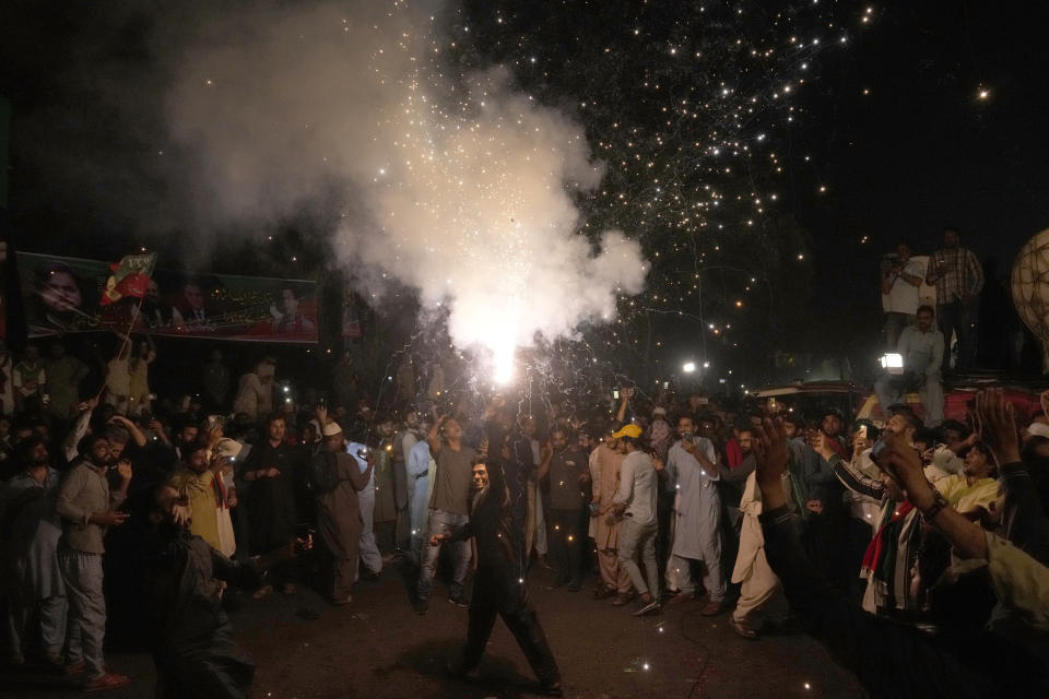 Supporters of former Prime Minister Imran Khan hold firework to celebrate their leader's release at outside his home in Lahore, Pakistan, Saturday, May 13, 2023. A high court in Islamabad on Friday granted Imran Khan protection from arrest in a graft case and ordered him freed on bail. (AP Photo/K.M. Chaudary)