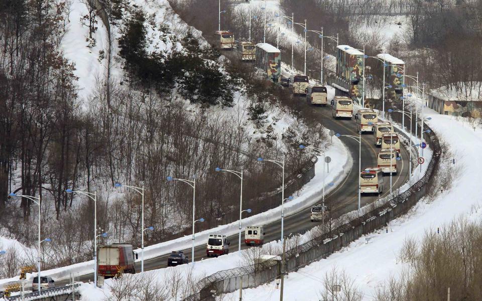 South Korean buses transporting participants of the family reunion cross the border line as they leave for Mount Kumgang resort in North Korea at Goseong, about 124 miles northeast of Seoul, February 20, 2014. (REUTERS/Lee Jong-geun/Yonhap)