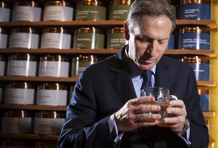 Howard Schultz, chief executive of Starbucks, smells a cup of tea as he poses for a portrait at his new Teavana store in New York, October 23, 2013. REUTERS/Carlo Allegri