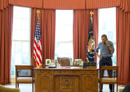 <p>President Barack Obama talks on the phone in the Oval Office with Russian President Vladimir Putin about the situation in Ukraine at the White House, March 1, 2014 in Washington, DC. After Russia’s upper parliament approved military action in Ukraine Obama and other leaders have suspended plans to attend a G8 summit in Russia as a response. (Pete Souza/The White House via Getty Images) </p>