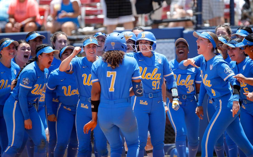 UCLA's Maya Brady (7) celebrates a home run with teammates in the seventh inning of a 7-3 win against Oklahoma on Monday in the first semifinal game against the Sooners.