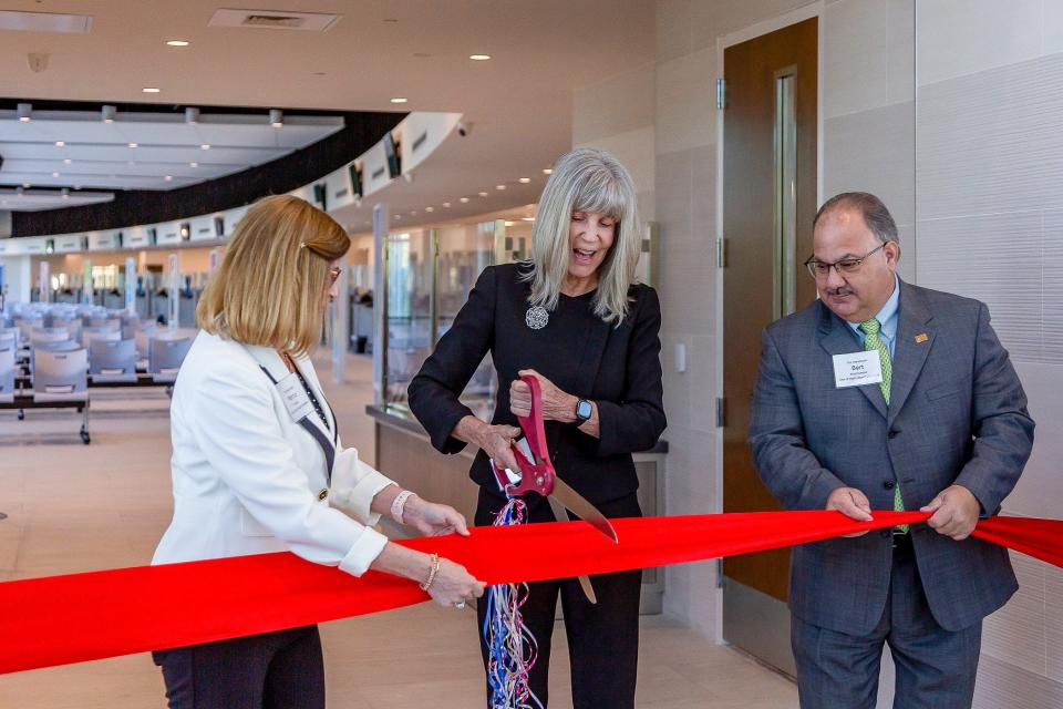 Left to right: Palm Beach Gardens Council member Marcie Tinsley, Palm Beach County Tax Collector Anne Gannon and Palm Beach Gardens Council member Bert Premuroso cut a ceremonial ribbon during a media event for the new north county service center of the county tax collector's offices on the morning of February 20, 2024, in Palm Beach Gardens, Fla.