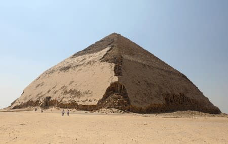 People walk in front of the Bent Pyramid of Sneferu, that was reopened after restoration work, in Dahshur, south of Cairo