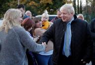 Britain's Prime Minister Boris Johnson is greeted during a general election campaign trail stop at Thornton-Cleveleys railway station in Manchester