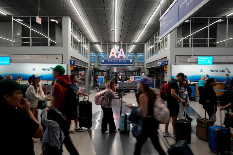 PHOTO: In this Aug. 7, 2023 file photo, passengers stand in line to check in luggage at an American Airlines ticket baggage counter at O'Hare International Airport, in Chicago.  (Kirby Lee/AP, FILE)