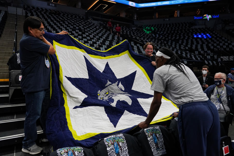 MINNEAPOLIS, MN - AUGUST 12: Fans present a gift to Sylvia Fowles #34 of the Minnesota Lynx before the start of the game against the Seattle Storm at Target Center on August 12, 2022 in Minneapolis, Minnesota. Fowles is retiring at the end of the season. NOTE TO USER: User expressly acknowledges and agrees that, by downloading and or using this Photograph, user is consenting to the terms and conditions of the Getty Images License Agreement. (Photo by David Berding/Getty Images)