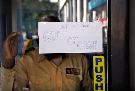 A notice is displayed on the gate of an automated teller machine (ATM) counter which is no longer dispensing cash in Chandigarh, India, November 21, 2016. REUTERS/Ajay Verma/Files