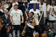 Milwaukee Bucks forward Giannis Antetokounmpo (34) holds the finals MVP trophy after the Bucks defeated the Phoenix Suns in Game 6 of basketball's NBA Finals in Milwaukee, Tuesday, July 20, 2021. The Bucks won 105-98. (AP Photo/Paul Sancya)