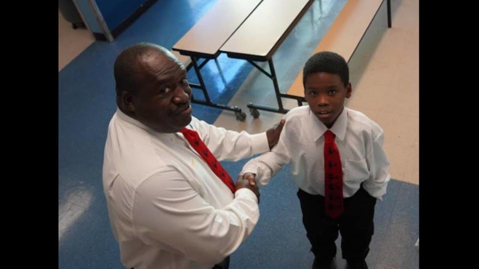 Holmes Elementary School math teacher Abe Coleman with one of the students he had mentored as part of his leadership role with the 5000 Role Models of Excellence Program at the Liberty City School.