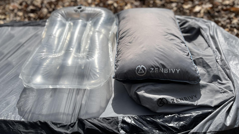 Parts of a Zenbivy pillow, laid out on a Zenbivy mattress and sheet.