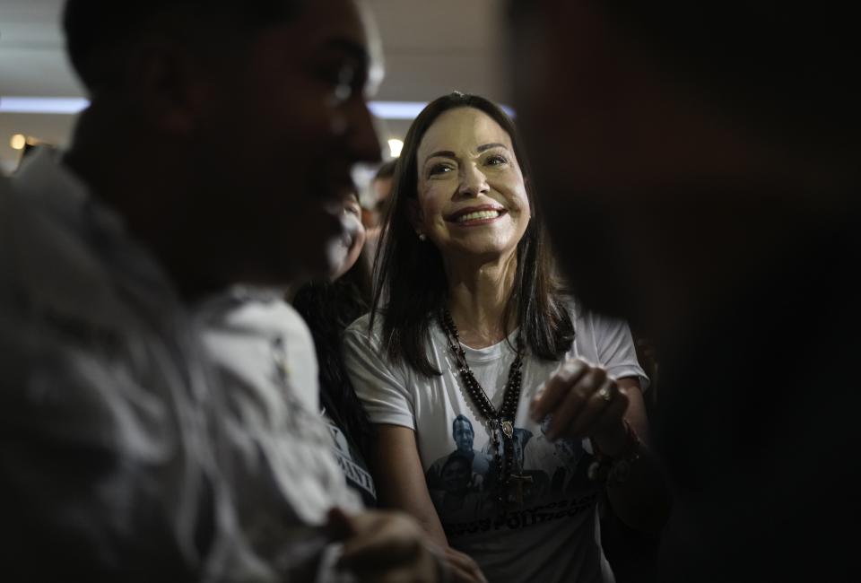 Opposition leader Maria Corina Machado, who has been banned from running for office, meets with supporters as she campaigns for the opposition's candidate in Maracaibo, Venezuela, Friday, May 3, 2024. Venezuela's opposition is rallying behind the unknown former diplomat Edmundo Gonzalez to challenge Nicolas Maduro in the July 28th presidential election. (AP Photo/Ariana Cubillos)