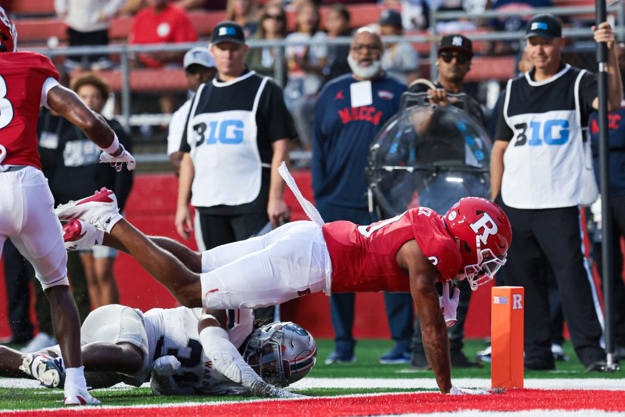 Aug 29, 2024; Piscataway, New Jersey, USA; Rutgers Scarlet Knights wide receiver Dymere Miller (0) scores a receiving touchdown during the first half as Howard Bison defensive back Joseph Tabe (31) defends at SHI Stadium.