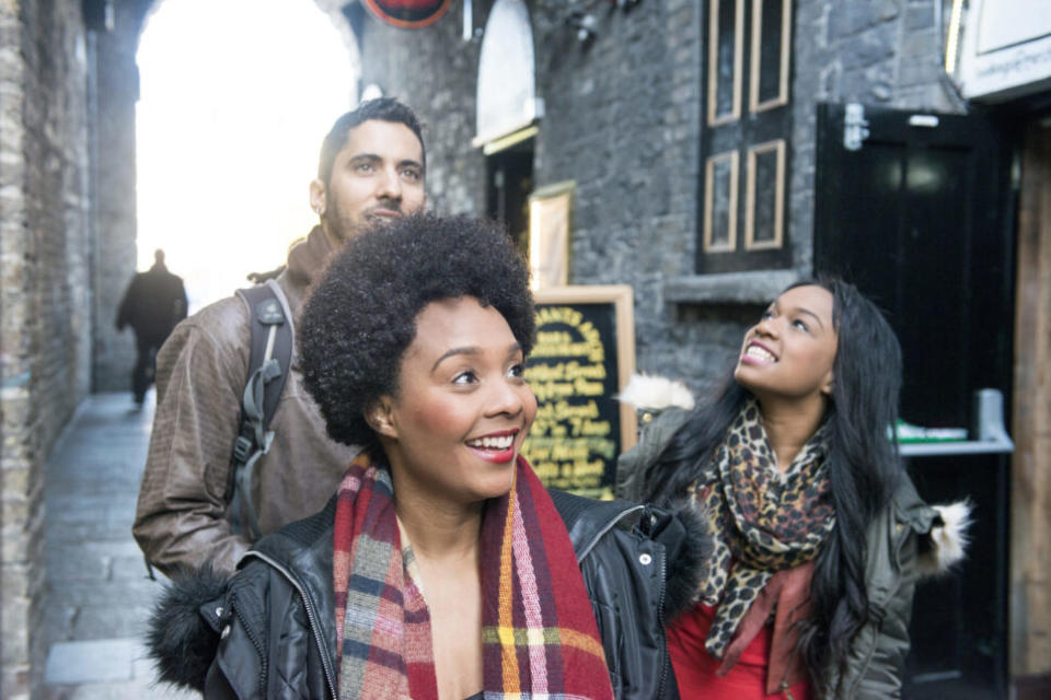 A group of tourists exploring Temple Bar, Dublin city centre, Ireland.