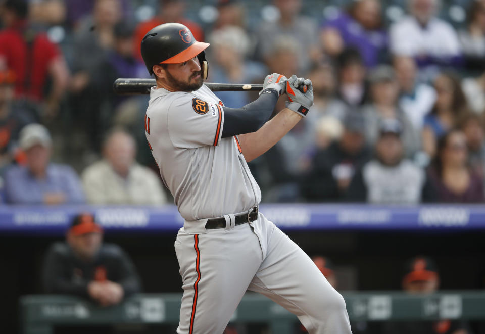 Baltimore Orioles' Trey Mancini follows through with his swing after connecting for a double against the Colorado Rockies in the first inning of a baseball game Friday, May 24, 2019, in Denver. (AP Photo/David Zalubowski)