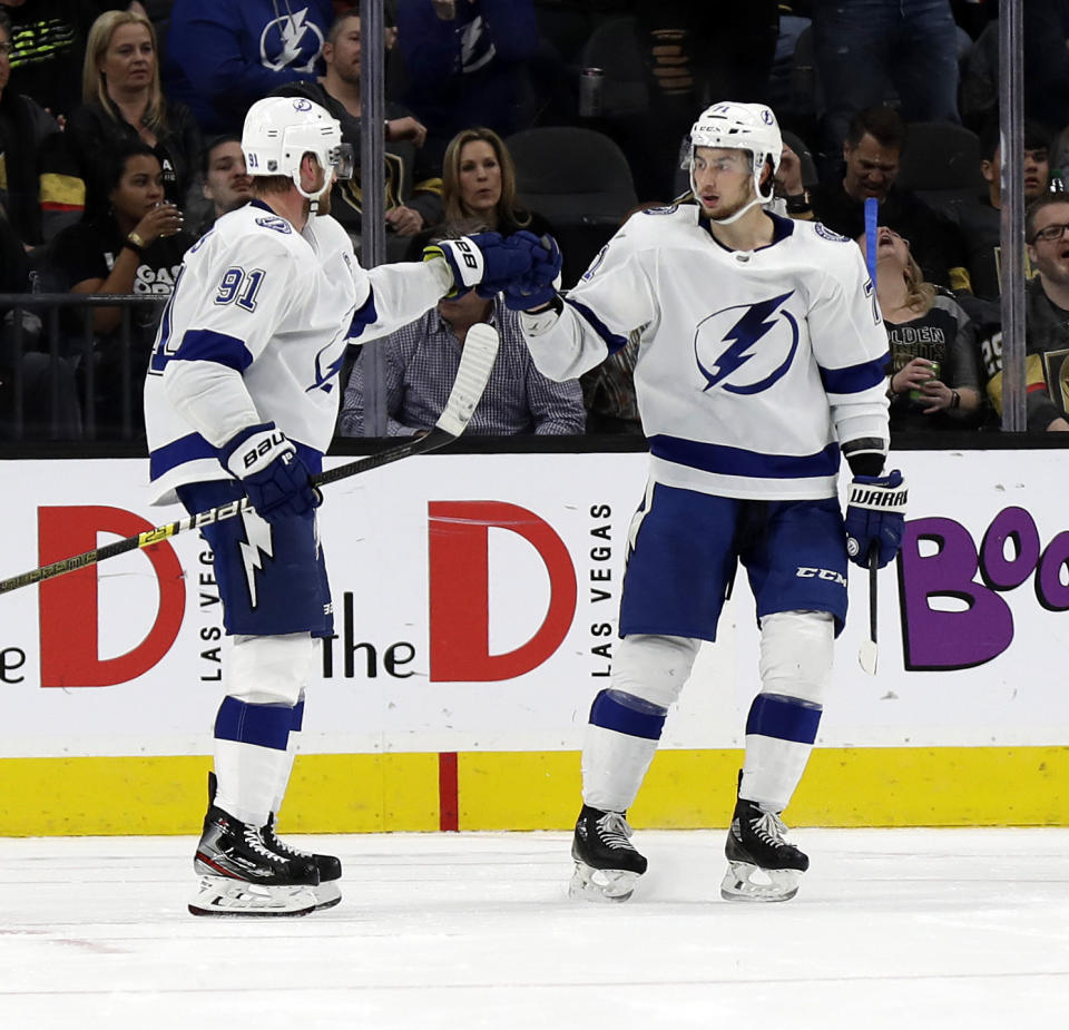 Tampa Bay Lightning forward Steven Stamkos (91) celebrates with forward Anthony Cirelli (71) after scoring during the second period of an NHL hockey game against the Vegas Golden Knights on Thursday, Feb. 20, 2020, in Las Vegas. (AP Photo/Isaac Brekken)