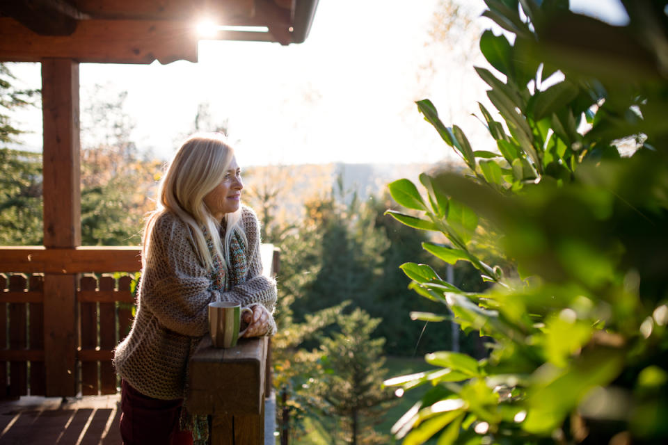 Woman peacefully observing nature on deck