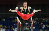 Germany's Fabian Hambuechen competes on the parallel bars in the qualification round on the horizontal bar during the London 2012 Olympic Games Artistic Gymnastics competition, London, Britain, 28 July 2012. EPA/Rolf Vennenbernd