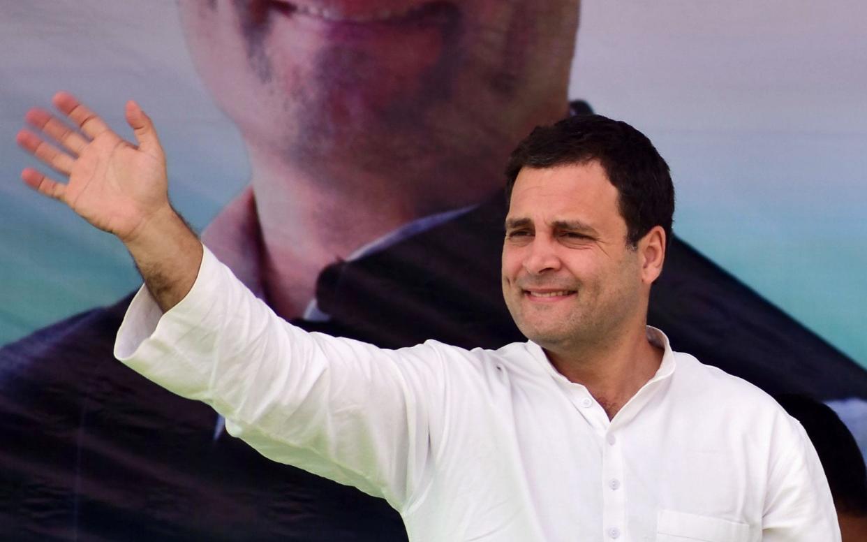 Rahul Gandhi waves to supporters during an election rally  - AFP