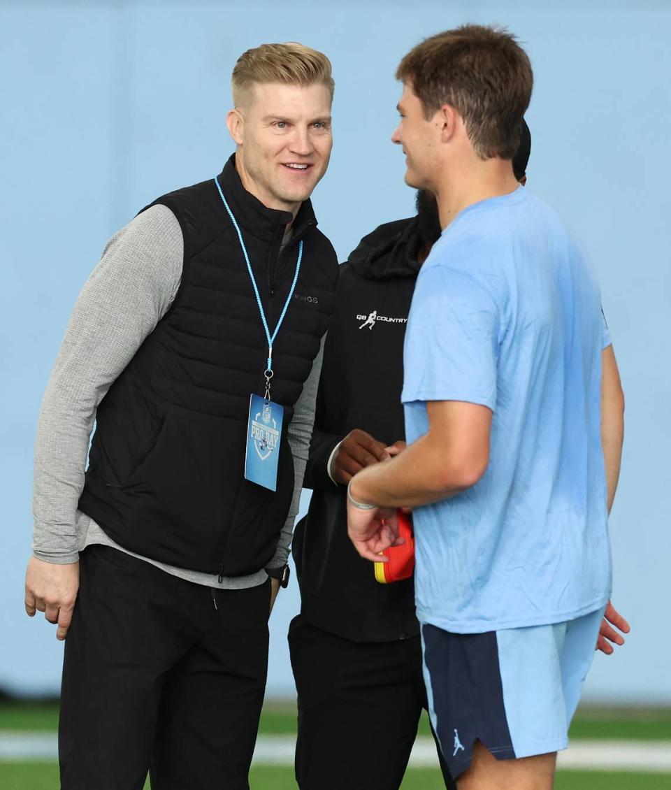 Josh McCown, left, speaks with quarterback Drake Maye following the quarterbacks series of drills during the Carolina Football Pro Day at UNC Chapel Hill’s Koman Indoor Practice Facility on Thursday, March 28, 2024. McCown was Maye’s high school quarterback coach.