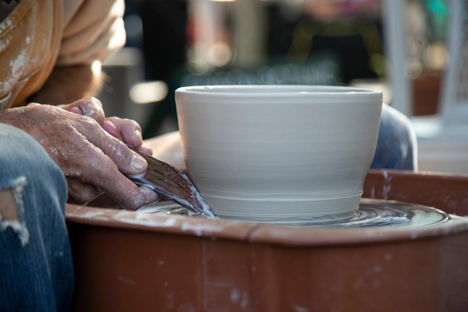 Joseph Mayhew of JM Pottery in Cape Coral works on a pot during the Edison & Ford Winter Estates Garden Festival.