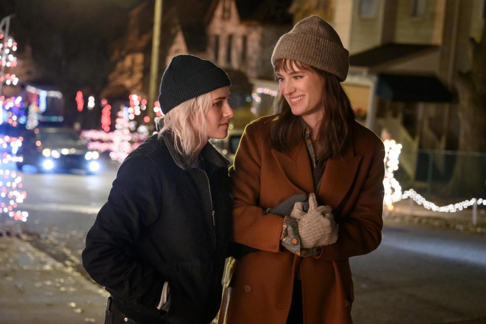 Kristen Stewart (left) and Mackenzie Davis star as a lesbian couple whose relationship is tested by a holiday family get-together in the romantic comedy "Happiest Season."