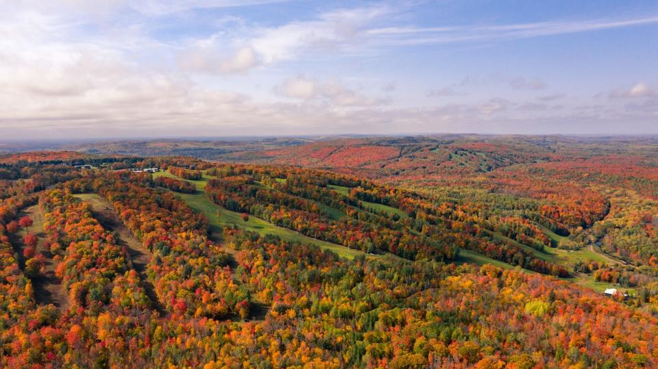 An aerial view of Snowriver Mountain Resort near Bessemer in Michigan's Upper Peninsula in fall.  Jackson Creek Summit, formerly known as Indianhead Mountain, is in the foreground.