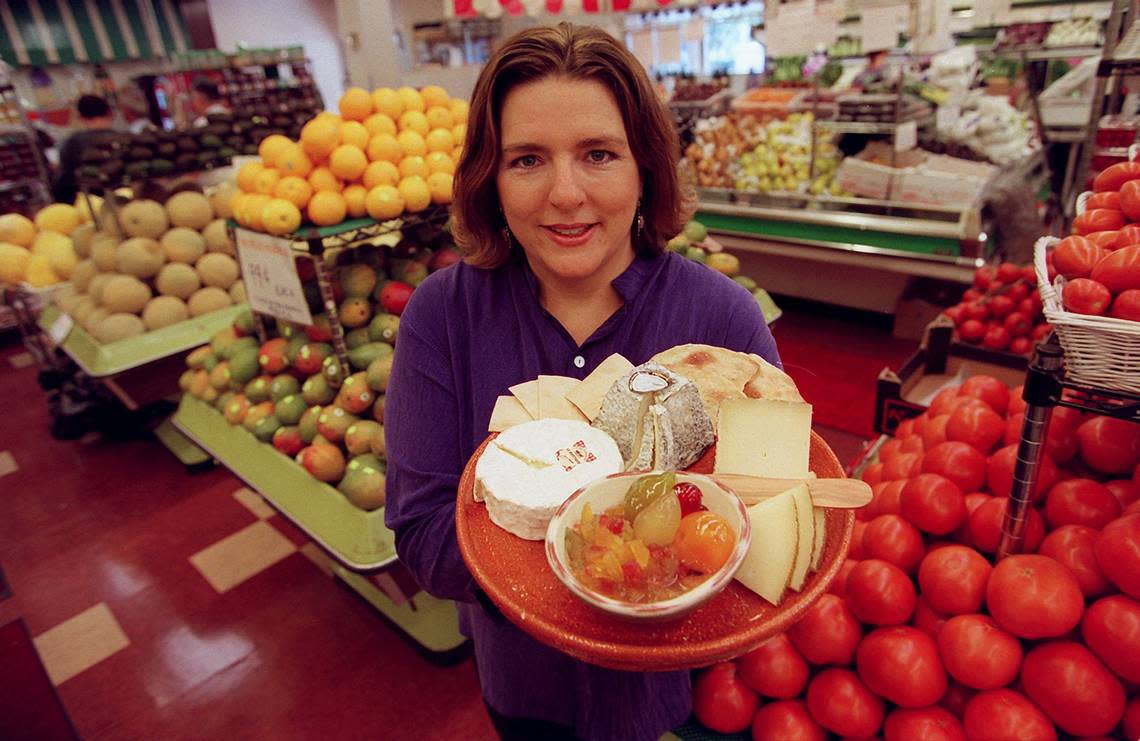Sarah Freedman-Izquierdo of Epicure Market shows some of the cheese at the Miami Beach store in 2001. Nuri Vallbona/Miami Herald File / 2001
