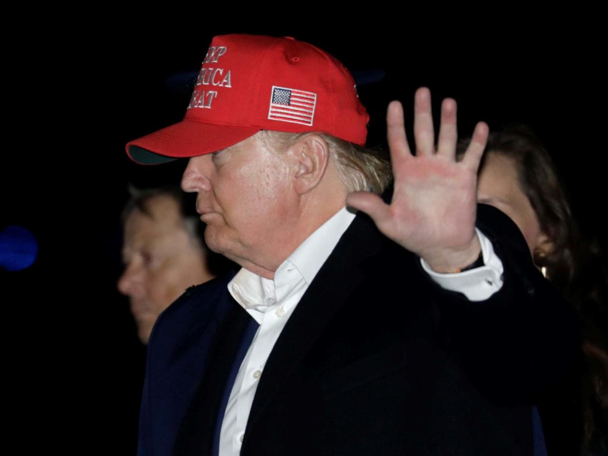 US president Donald Trump waves after disembarking Air Force One upon arriving in Joint Base Andrews, Maryland, after their Thanksgiving vacation on 1 December 2019: Yuri Gripas/Reuters