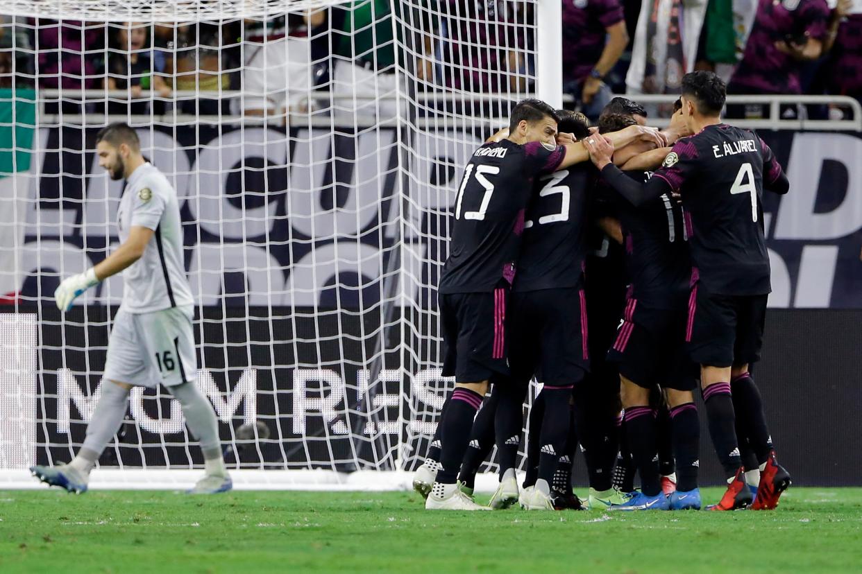 México celebra un gol del mediocampista Orbelin Pineda mientras el arquero canadiense Maxime Crepeau, izquierda, se aleja durante la primera mitad de una semifinal de fútbol de la Copa Oro de la CONCACAF el jueves 29 de julio de 2021 en Houston, Texas. (AP/Michael Wyke)