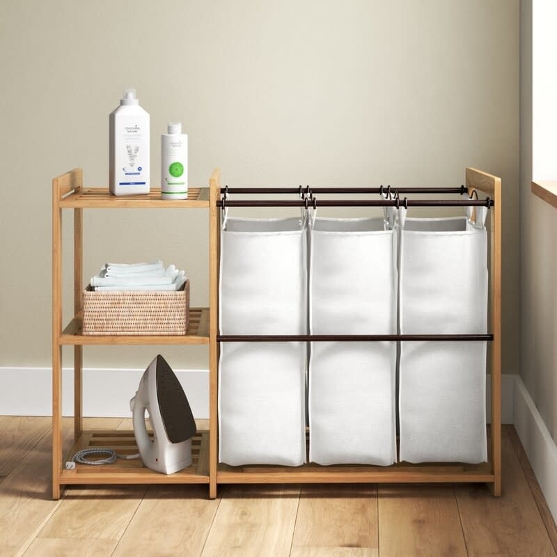 The laundry sorter with cleaning products on its shelves