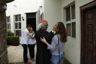 FILE - A woman receives a blessing from Cardinal Leopoldo Brenes outside the Jesus of Divine Mercy church, which had come under attack by heavily armed pro-government groups, in Managua, Nicaragua, July 22, 2018. Managua’s cathedral sheltered student demonstrators in 2018 and was a place for collecting food and money to support them. (AP Photo/Arnulfo Franco, File)