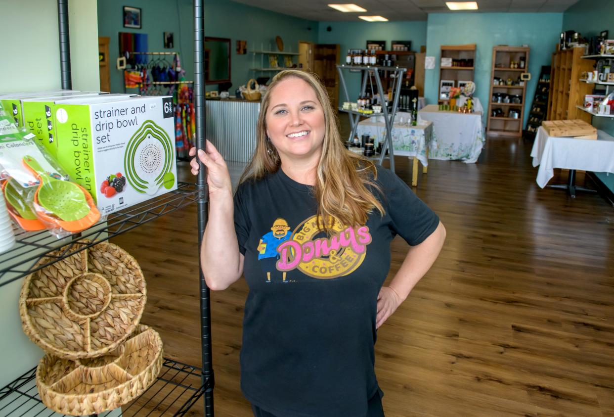 Andrea Vincent stands in her new kitchen boutique, Little Mojo's Kitchen Boutique, next to Big Mike's Donuts & Coffee, the shop she runs with partner Mike Henry, at 1369 W. Garfield Avenue in Bartonville. The boutique opened officially on Aug. 12.