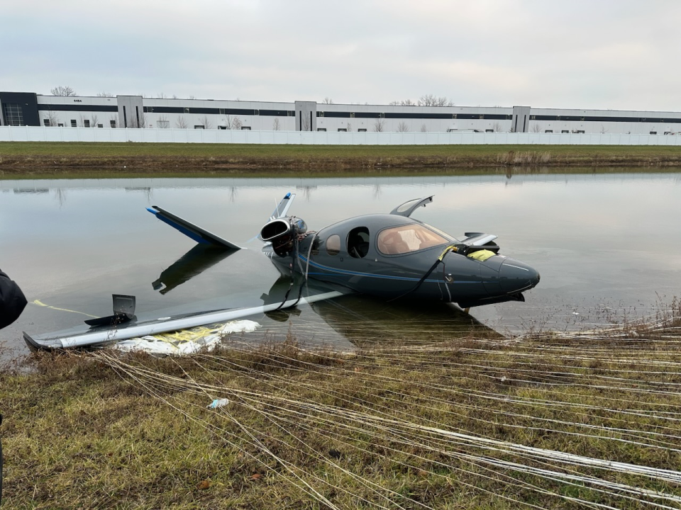 The Cirrus Vision Jet SF50 landed via parachute in a retention pond near Interstate 70 west of Greenfield, Indiana.