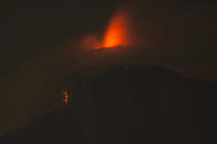 <p>In this image taken with a long exposure, the Volcan de Fuego, or Volcano of Fire, spews molten rock from its crater in Alotenango, Guatemala, June 3, 2018. (Photo: Luis Soto/AP) </p>