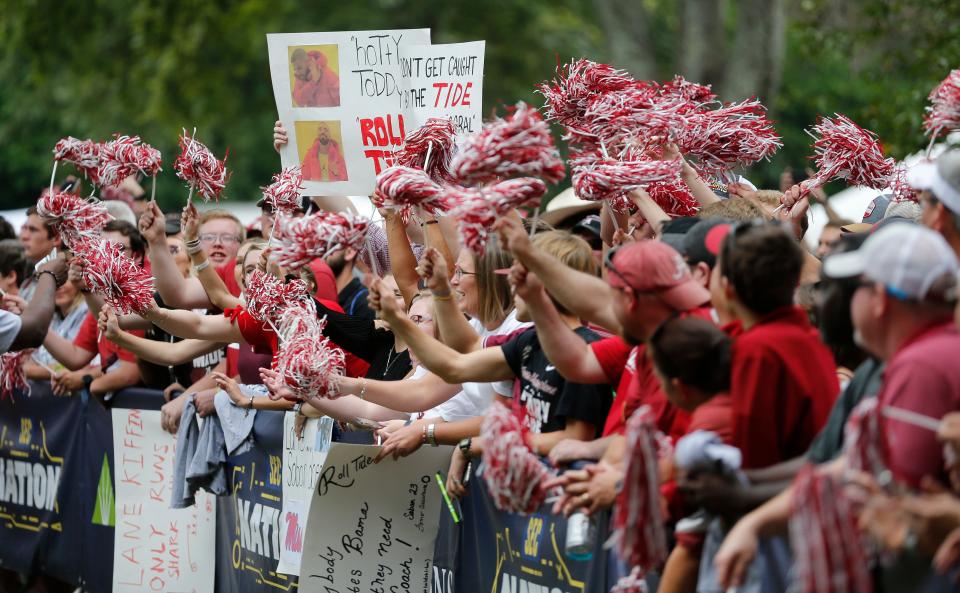 Oct 2, 2021; Tuscaloosa, Alabama, USA; Fans cheer behind a television stage at Bryant-Denny Stadium. Mandatory Credit: Gary Cosby-USA TODAY Sports