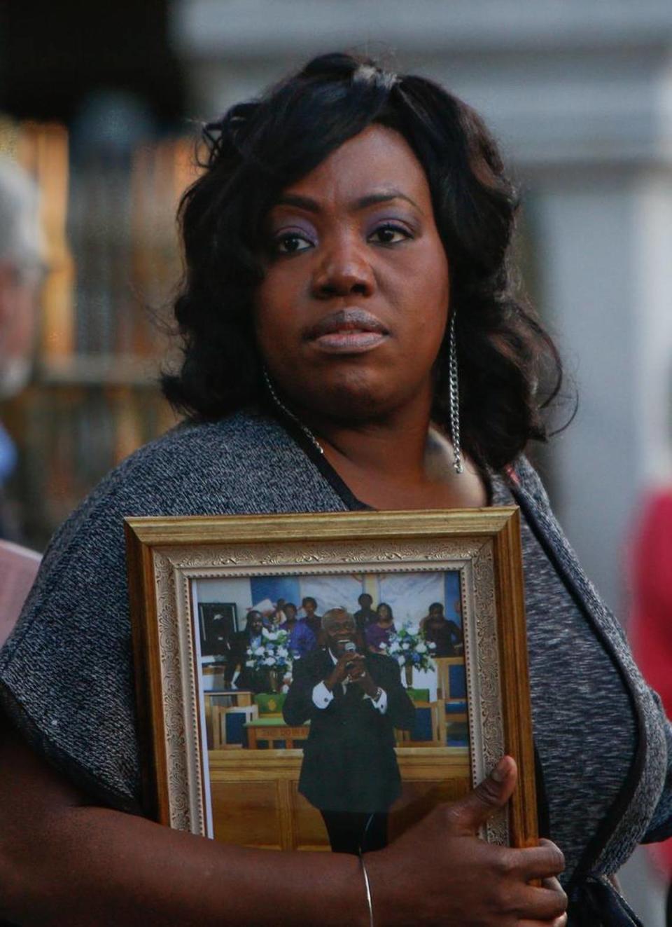 Rose Simmons, whose father, Rev. Daniel Simmons, was killed along with eight others by Dylann Roof during a Bible study at Mother Emanuel AME Church, holds a photograph of her father after Roof’s sentencing.