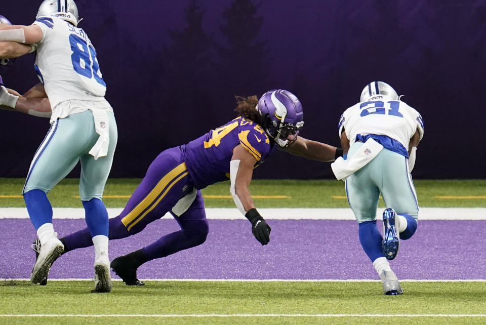 Dallas Cowboys running back Ezekiel Elliott (21) scores on a 6-yard touchdown reception ahead of Minnesota Vikings linebacker Eric Kendricks (54) during the first half of an NFL football game, Sunday, Nov. 22, 2020, in Minneapolis. (AP Photo/Jim Mone)