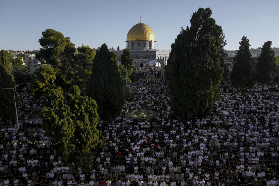 Muslim worshipers offer Eid al-Adha prayers next to the Dome of the Rock shrine at the Al Aqsa Mosque compound in Jerusalem's Old City, Saturday, July 9, 2022. The major Muslim holiday, at the end of the hajj pilgrimage to Mecca, is observed around the world by believers and commemorates prophet Abraham's pledge to sacrifice his son as an act of obedience to God. (AP Photo/Mahmoud Illean)