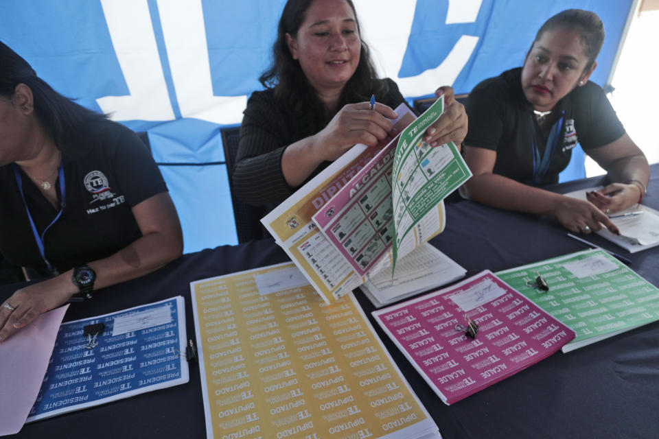 An electoral worker demonstrates how to properly handle ballots during a Voting Fair for citizens at the Electoral Tribunal headquarters in Panama City, Thursday, May 2, 2019. Panamanians head to the polls on Sunday, May 5, to elect a new president. (AP Photo/Arnulfo Franco)