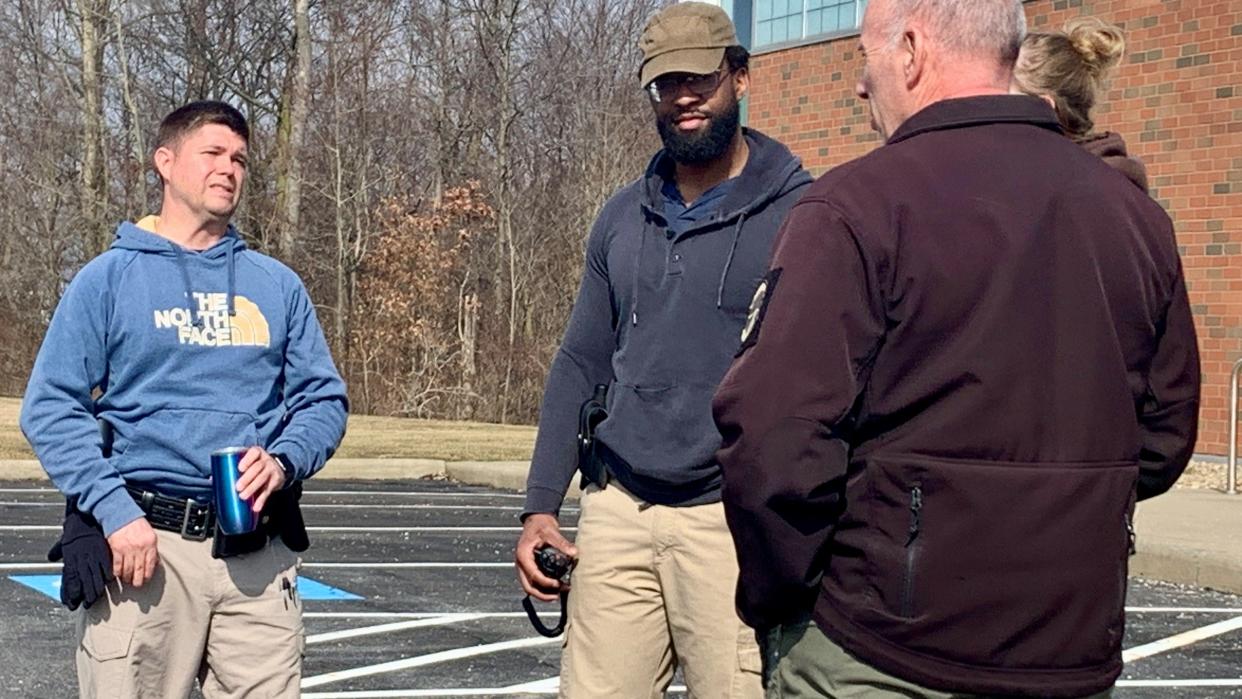 Canton police cadet Jamaal McClain, center, listens as Scott Coleman, a Stark State College law enforcement academy instructor, reviews traffic-stop training with Anthony Leighton, who was hired by Canton police in November.