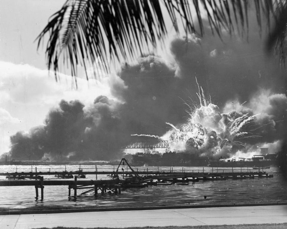 A navy photographer snapped this photograph of the Japanese attack on Pearl Harbor in Hawaii on December 7, 1941, just as the USS Shaw exploded. The stern of the USS Nevada can be seen in the foreground