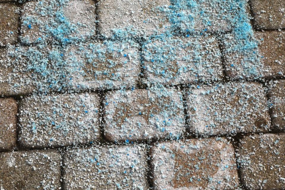 ice melt crystals on a paved sidewalk for snow removal