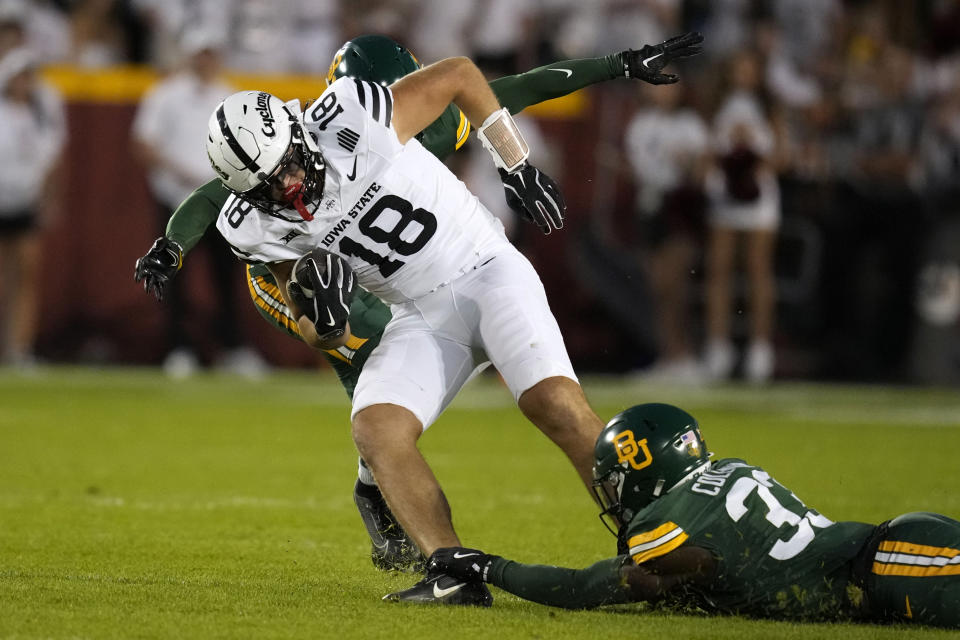 Iowa State tight end Benjamin Brahmer (18) is tackled by Baylor safety DJ Coleman (33) after catching a pass during the first half of an NCAA college football game, Saturday, Oct. 5, 2024, in Ames, Iowa. (AP Photo/Charlie Neibergall)