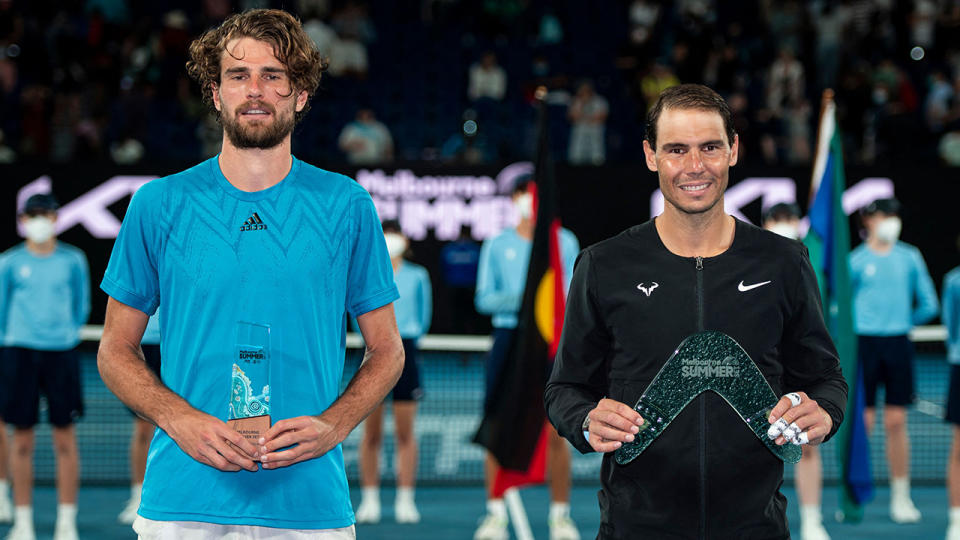 Maxime Cressy and Rafael Nadal are pictured with their trophies after the final if the Melbourne Summer Set. (Photo by MIKE FREY/AFP via Getty Images)