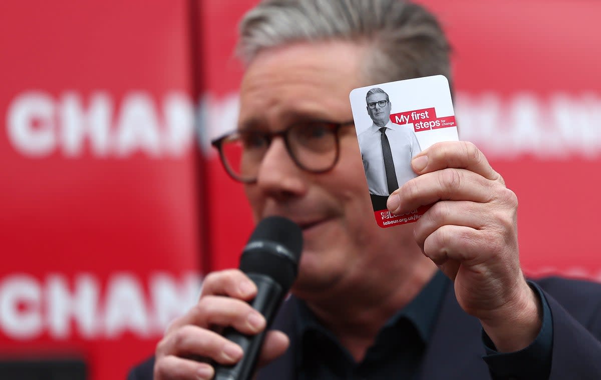 Labour Party Leader Sir Keir Starmer holds a card detailing his policy priorities at the launch of the Labour Party election campaign ‘Battle Bus’ in Uxbridge (Getty Images)