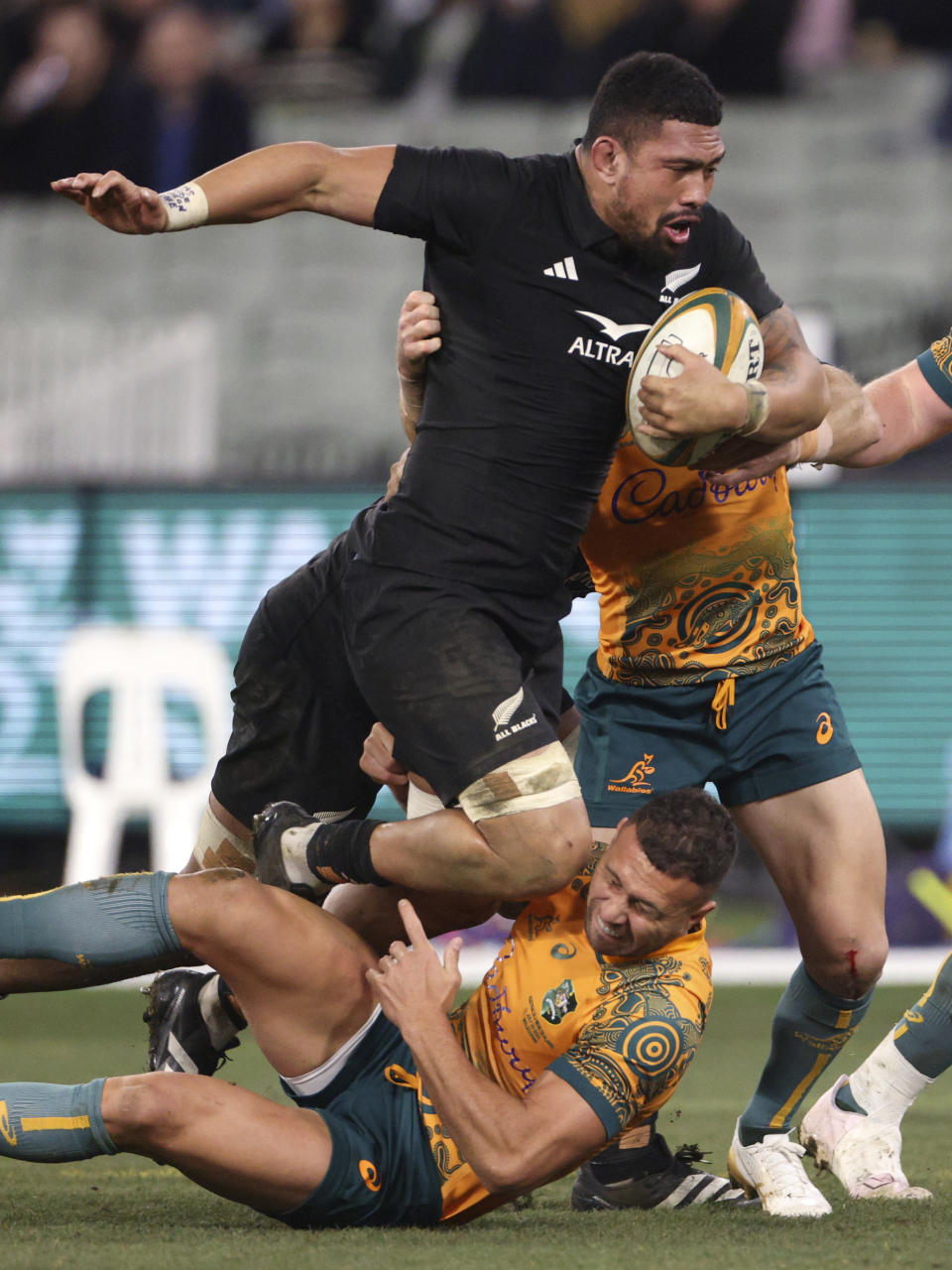 New Zealand's Ardie Savea, top runs over Australia's Quade Cooper during their Bledisloe Cup rugby union test match in Melbourne, Australia, Saturday, July 29, 2023. (AP Photo/Hamish Blair)