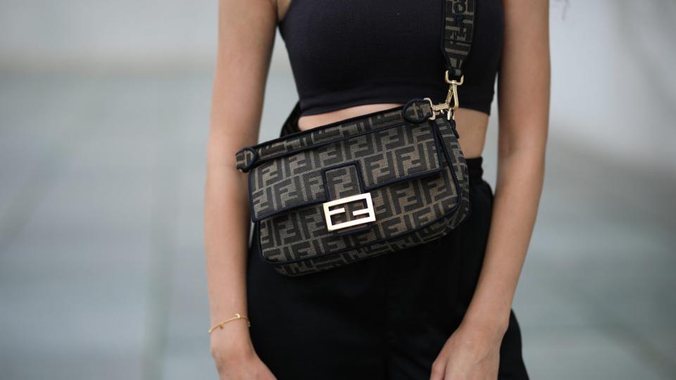 Woman in black wearing a Fendi Baguette