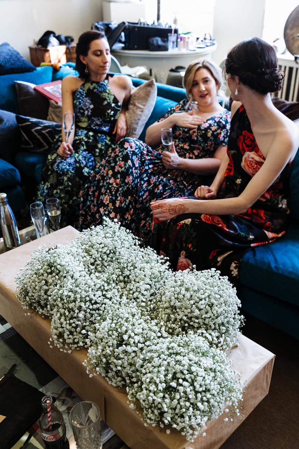 The bridesmaids relax with some Champagne before the ceremony on Saturday. I love how their bouquets went with their dark floral dresses.