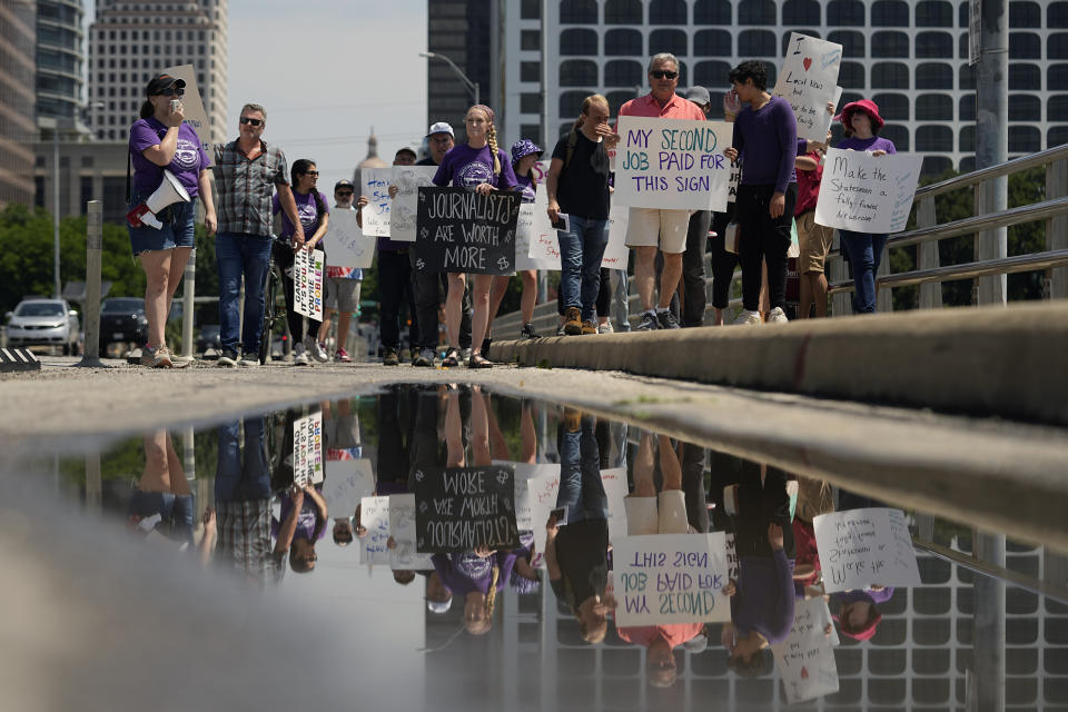 Editorial members of the Austin American-Statesman's Austin NewsGuild picket along the Congress Avenue bridge in Austin, Texas, Monday, June 5, 2023. The mostly one-day strike aims to protest the company's leadership and cost-cutting measures imposed since its 2019 merger with GateHouse Media. (AP Photo/Eric Gay)